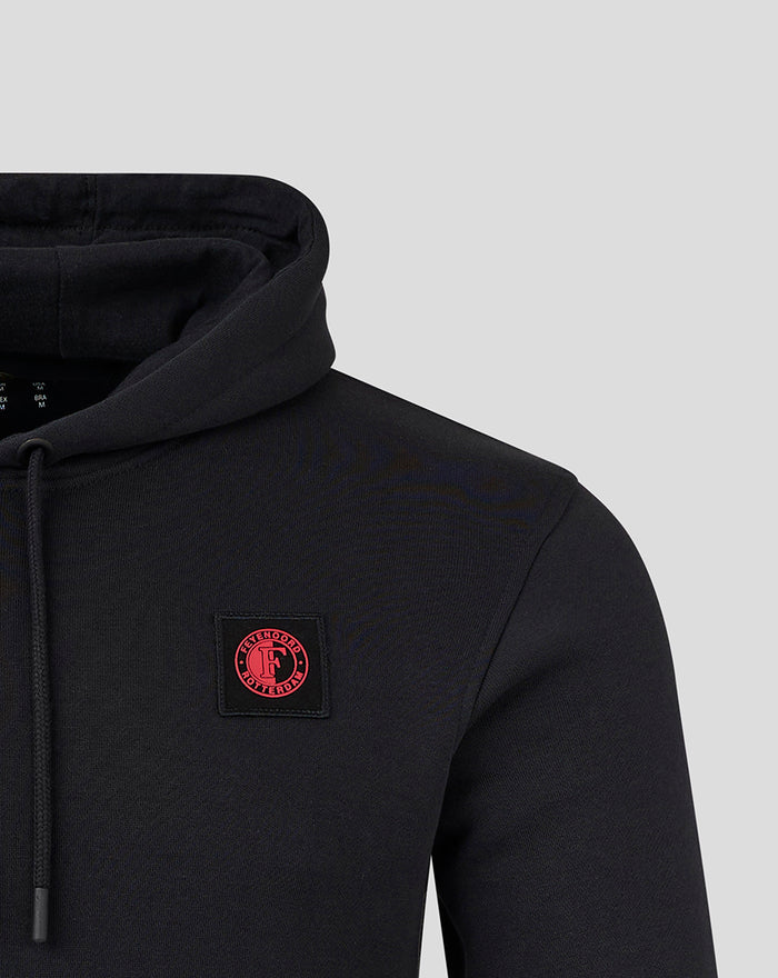 Close up of the black FEYENOORD Classic Hoody for men showing a red circular logo patch on the chest.