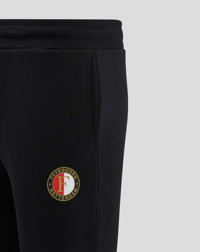 Close up side view of black Feyenoord Core joggers for men with a crest on the thigh