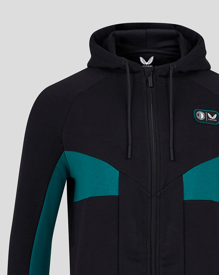Front view of black fleece hoodie with teal color blocks and small crest patch on the chest