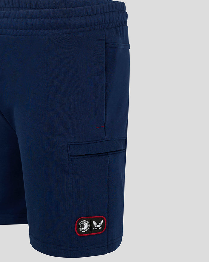Navy blue shorts with a red bordered patch near the hem displaying Feyenoord and Castore logos.