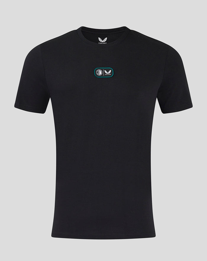 Black T shirt with a small dual badge patch on the chest featuring Feyenoord and Castore logos.