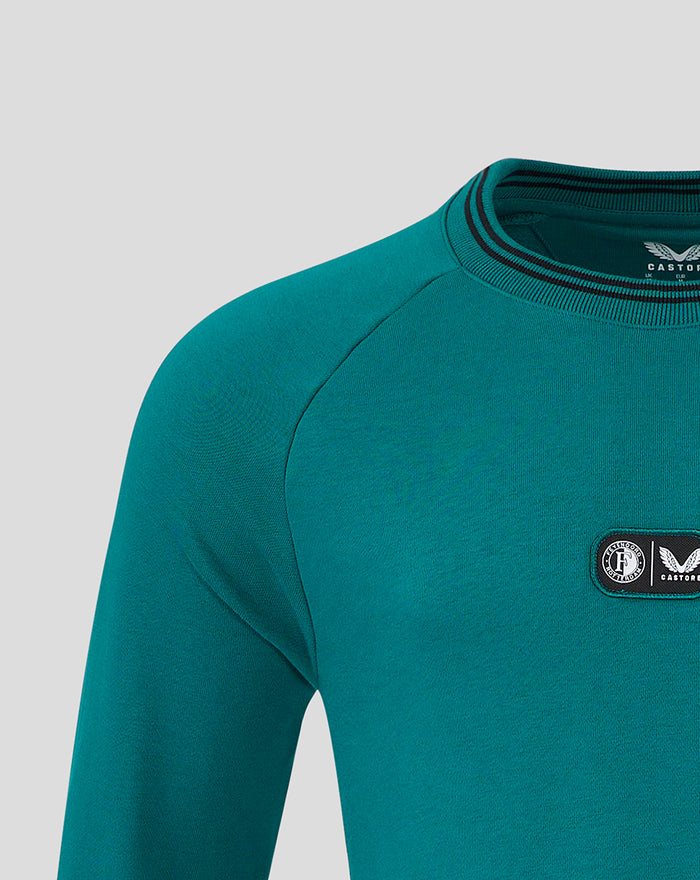 Teal Feyenoord x Castore fleece shirt chest area showing two logo patches and shoulder seam