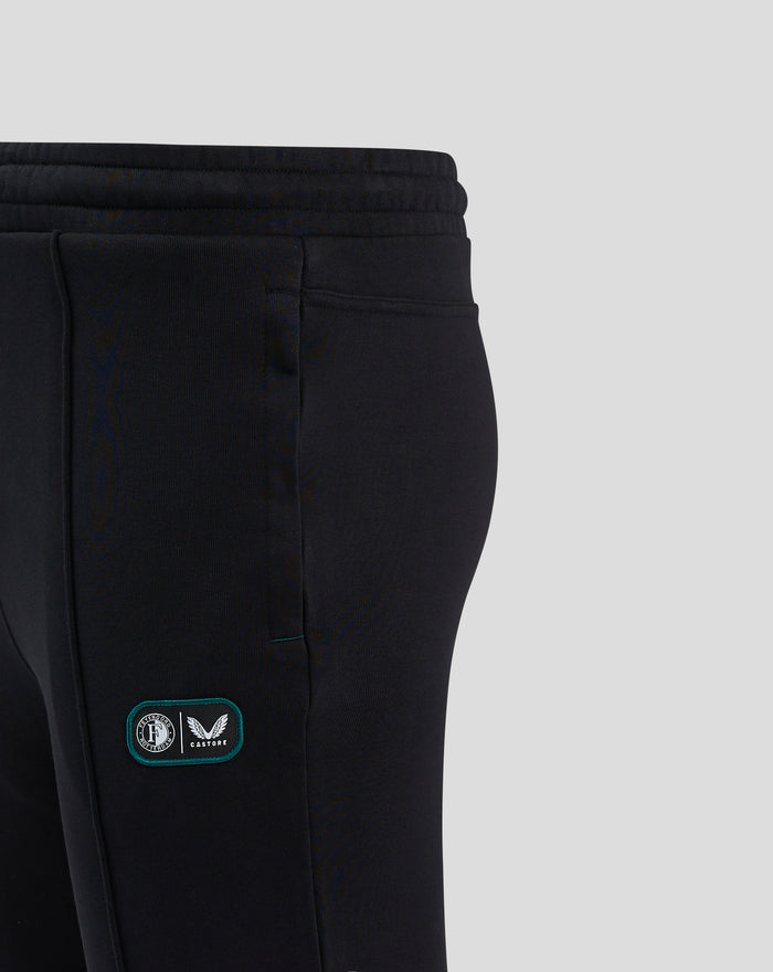 Close up of the waistband and a patch with Feyenoord crest and Castore logo on black joggers