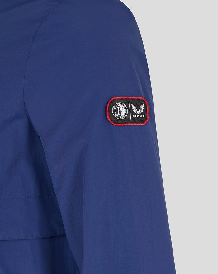 Blue jacket sleeve close-up with a patch displaying the club badge and Castore logo