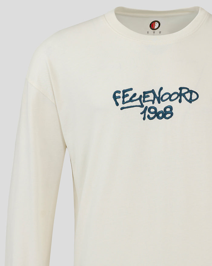 Close up of the chest showing blue embroidered Feyenoord 1908 on a cream long sleeve T shirt