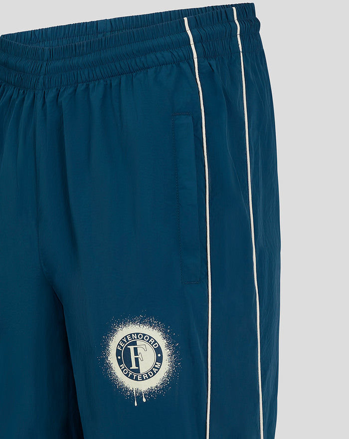 Front view of blue FEYENOORD training pants with white piping and a circular club logo on the thigh
