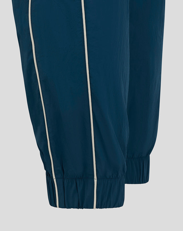 Close-up of blue FEYENOORD training pants showing white piping along the side seam and a stitched pocket detail