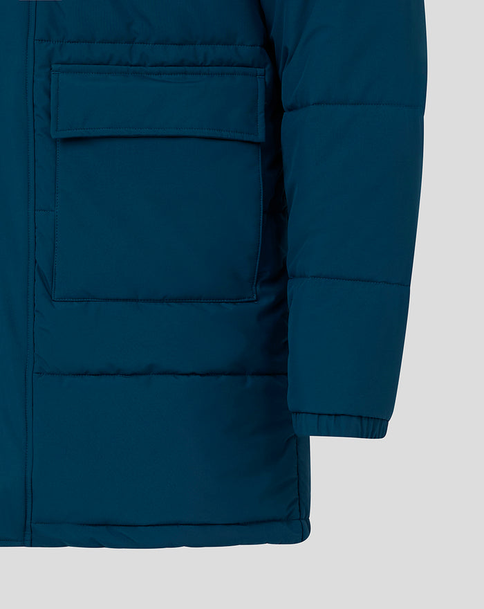 Front of blue parka showing a large pocket with flap and quilted body