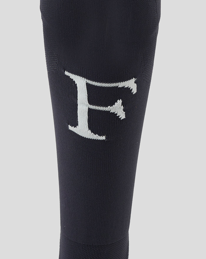 Navy Feyenoord outkousen close-up with a large white F on the shin and Castore logo on the calf