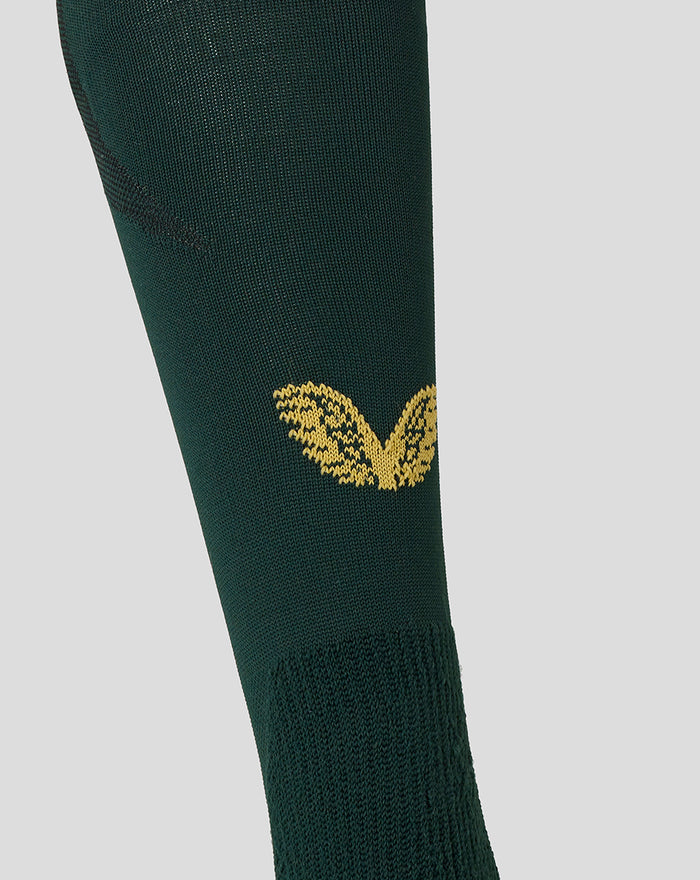 Calf area of dark green sock with gold wing crest and visible knit pattern