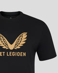 Close up of black T-shirt showing a gold wing emblem and partial gold text on the chest.