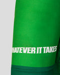 Close-up of the green marathon shirt hem with the white WHATEVER IT TAKES slogan