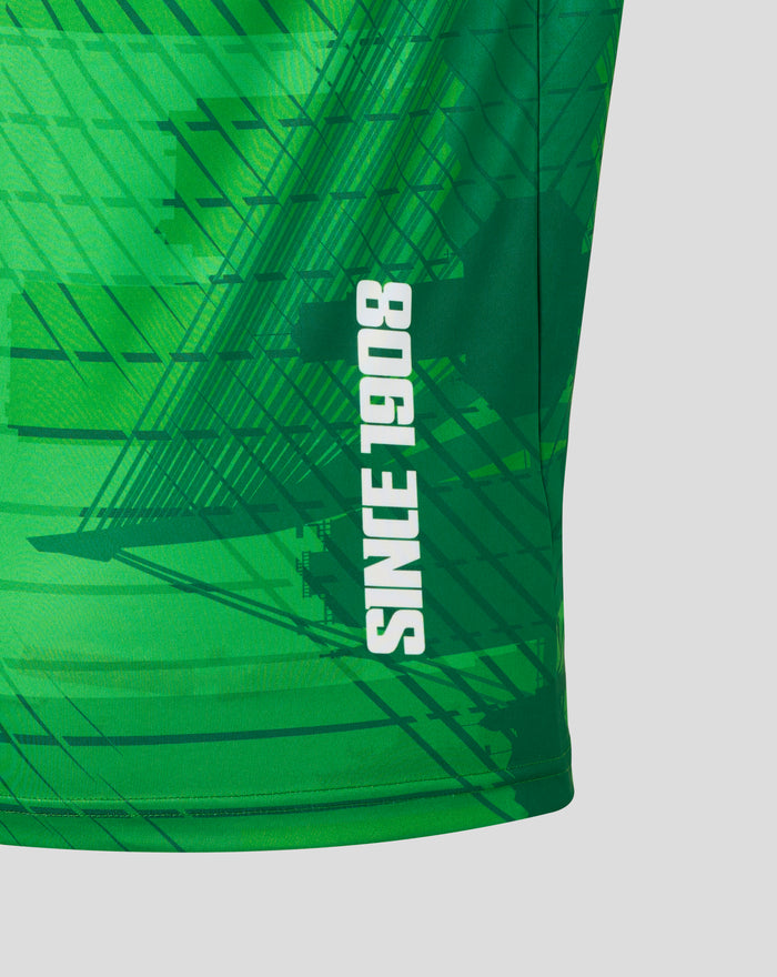Close-up of the green running shirt fabric with bold graphic lines and vertical white text along the side