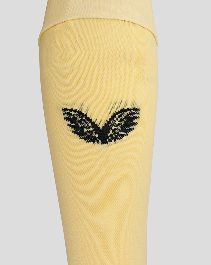 Close up of yellow Feyenoord Vierde Kousen sock showing a black decorative pattern on the lower leg