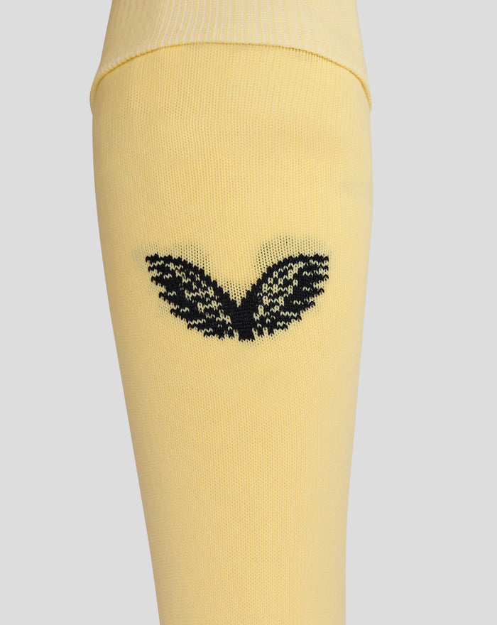 Close up of yellow Feyenoord Vierde Kousen sock showing a black decorative pattern on the lower leg