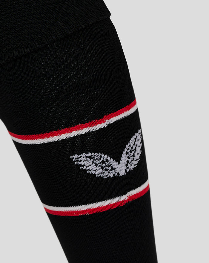 Close up of black Feyenoord home sock with red and white stripe and Castore logo on the calf