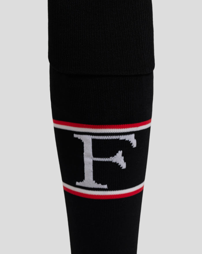 Detail shot of black Feyenoord sock showing embroidered white F and red white trim near the cuff
