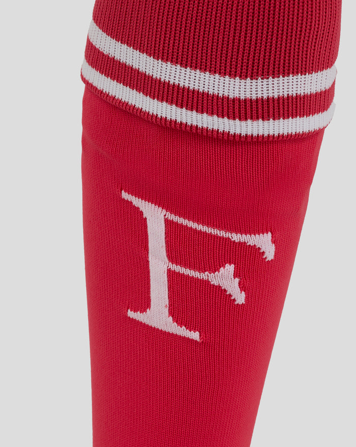 Red Feyenoord keeper sock close up with white striped cuff and Castore logo on calf