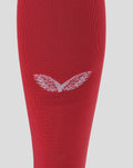 Close up of red knitted goalkeeper sock with white chevron pattern near the cuff.