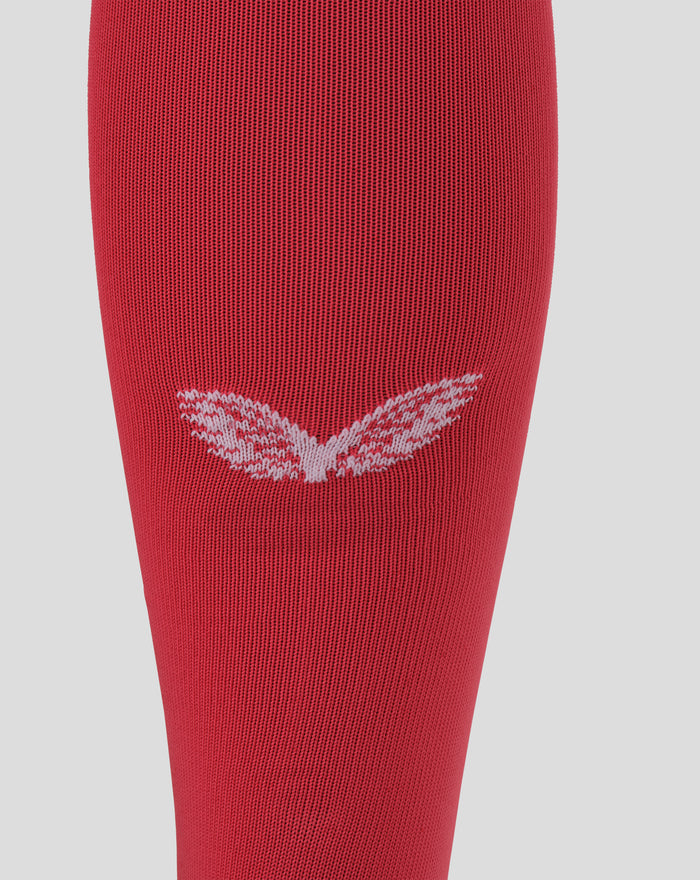 Close up of red knitted goalkeeper sock with white chevron pattern near the cuff.