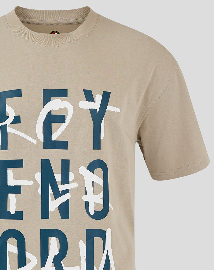 Close up of beige adult FEYENOORD contemporary T shirt showing large navy letters with white scribble overlay.