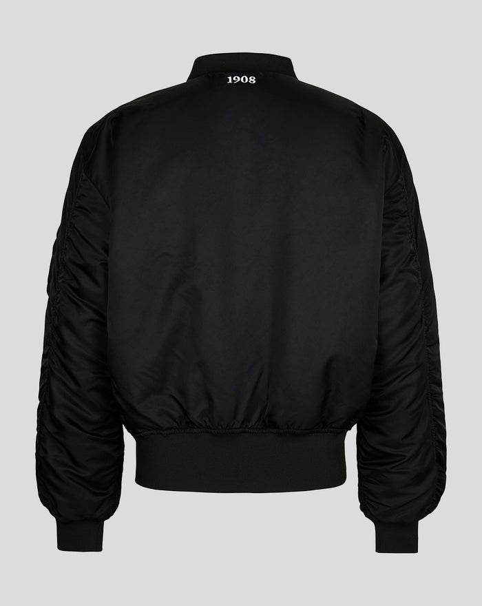 Back view of a black adult reversible stadium jacket with ribbed hem and cuffs